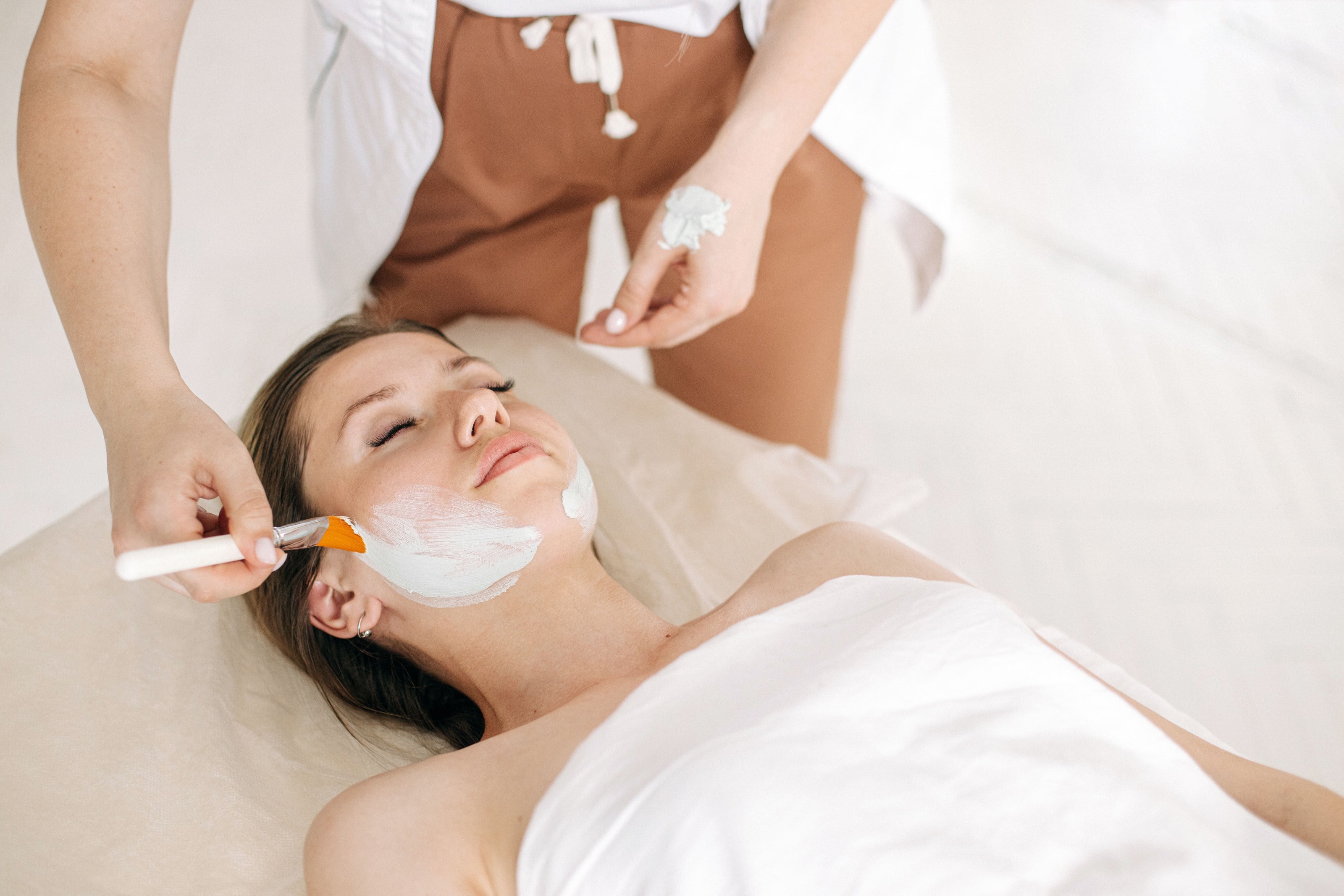 A facial in progress: a mask brushed onto a customer's face